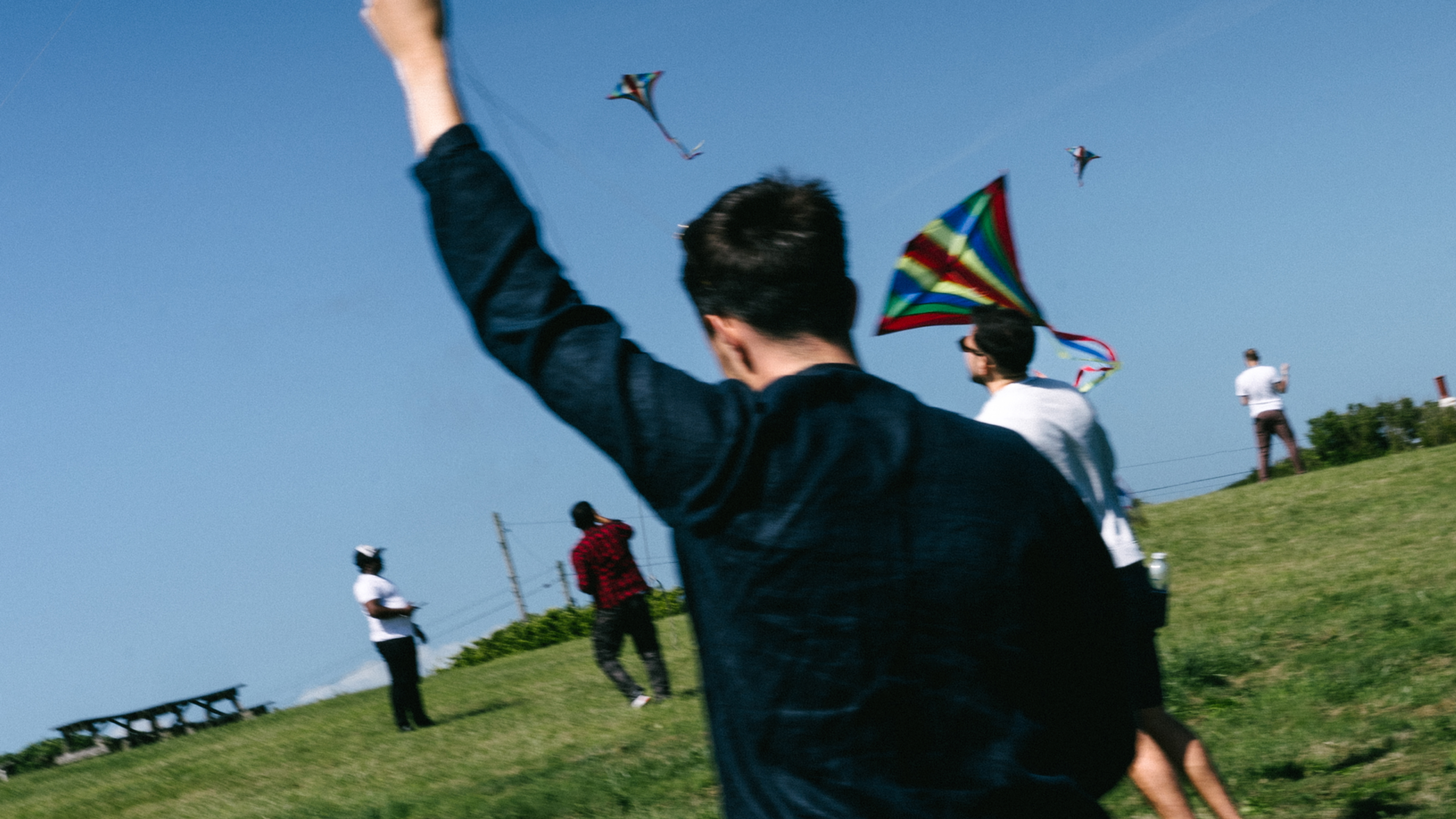 A group of young people flying kites