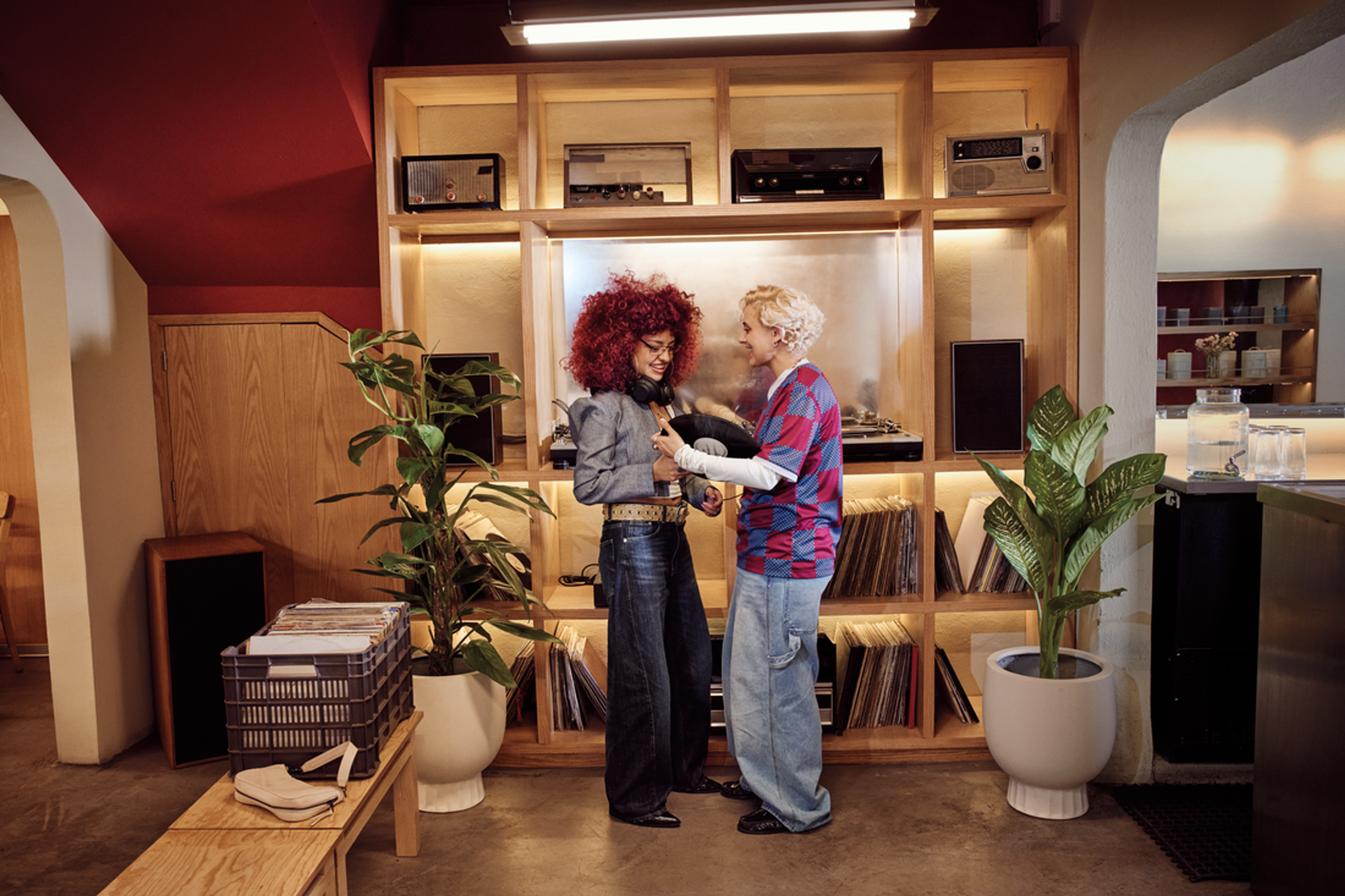two people at a record store on a date. one is showing the other a record