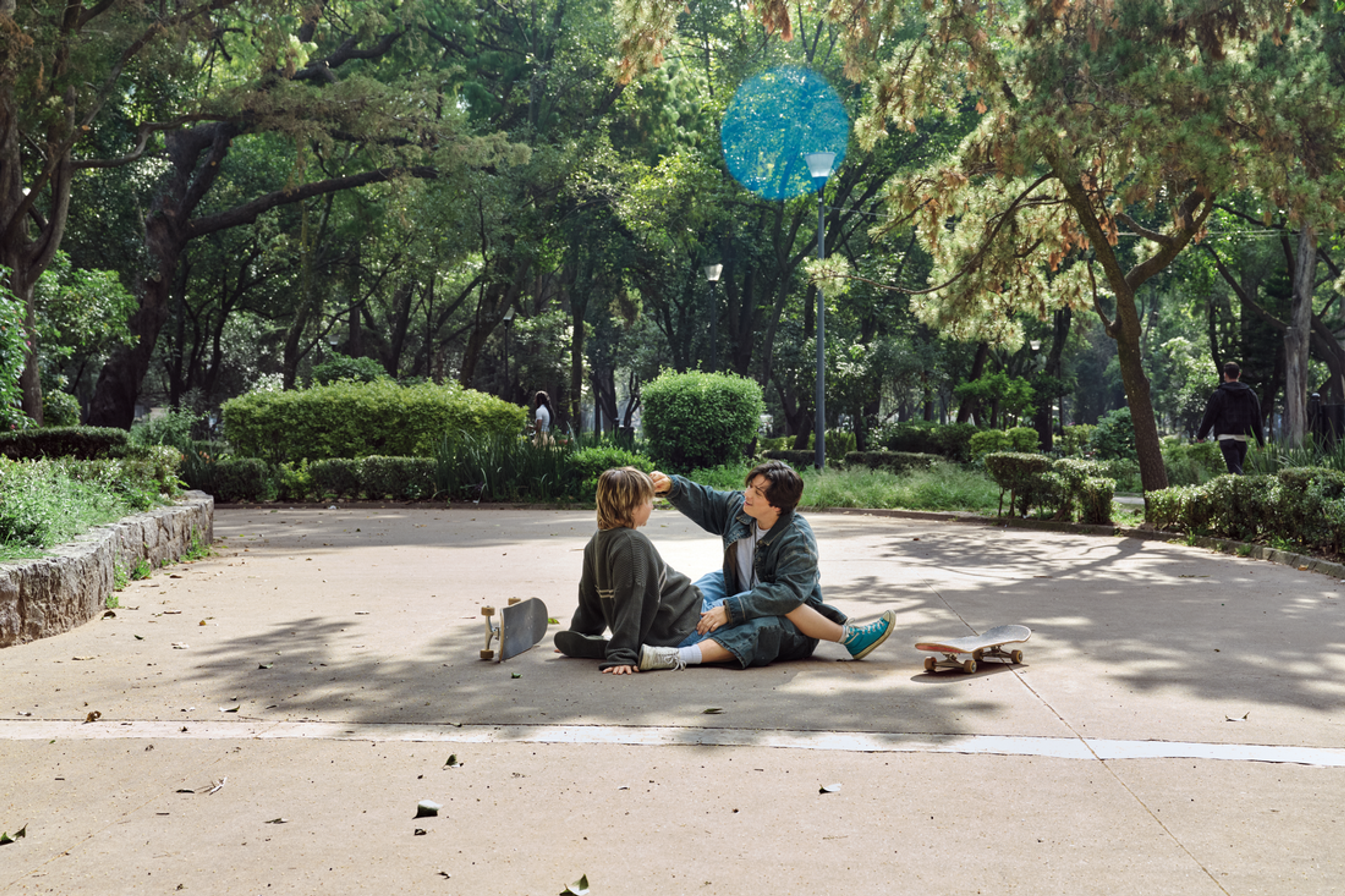 Queer couple sits together in park