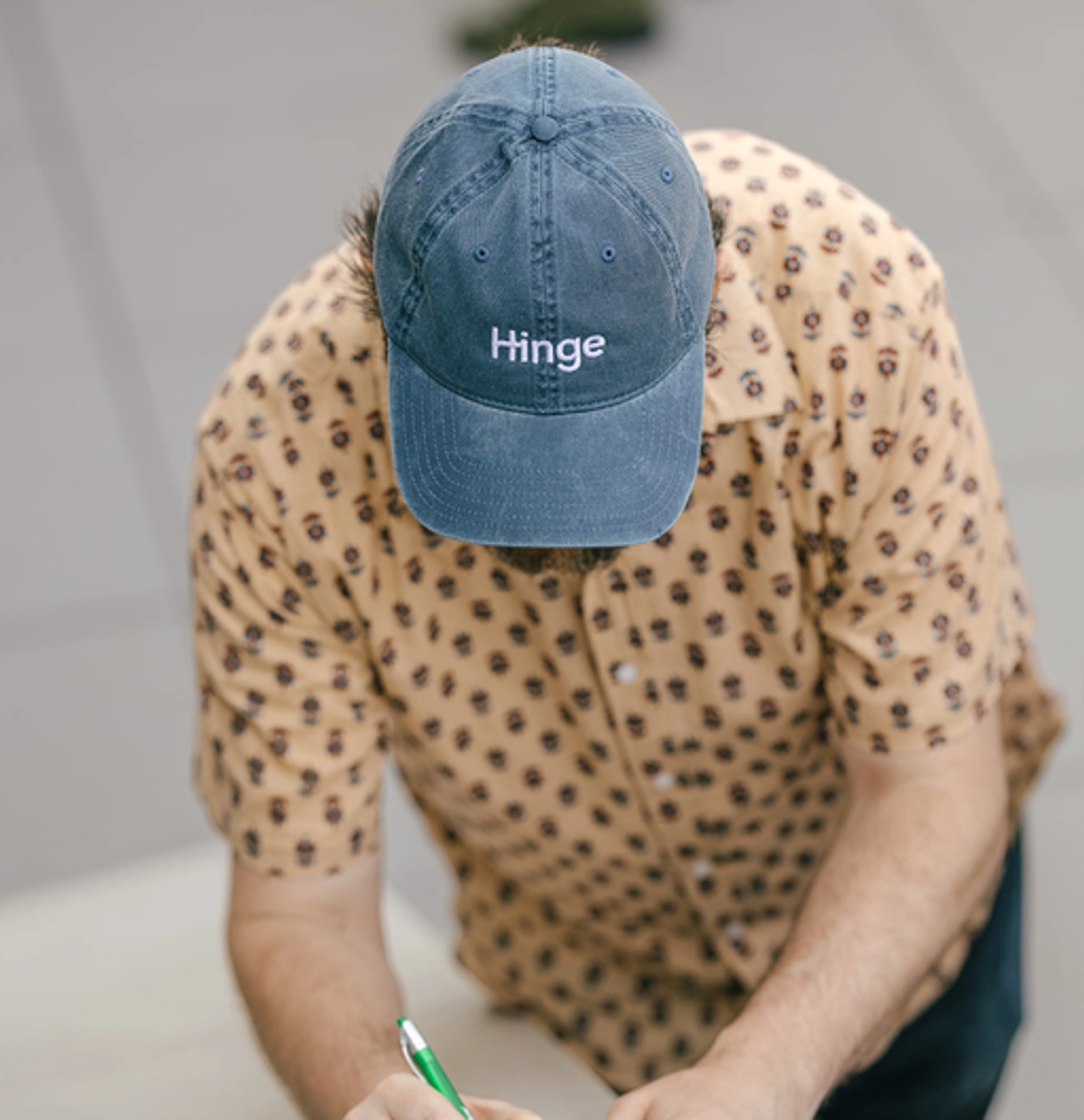 person wearing a hinge branded hat