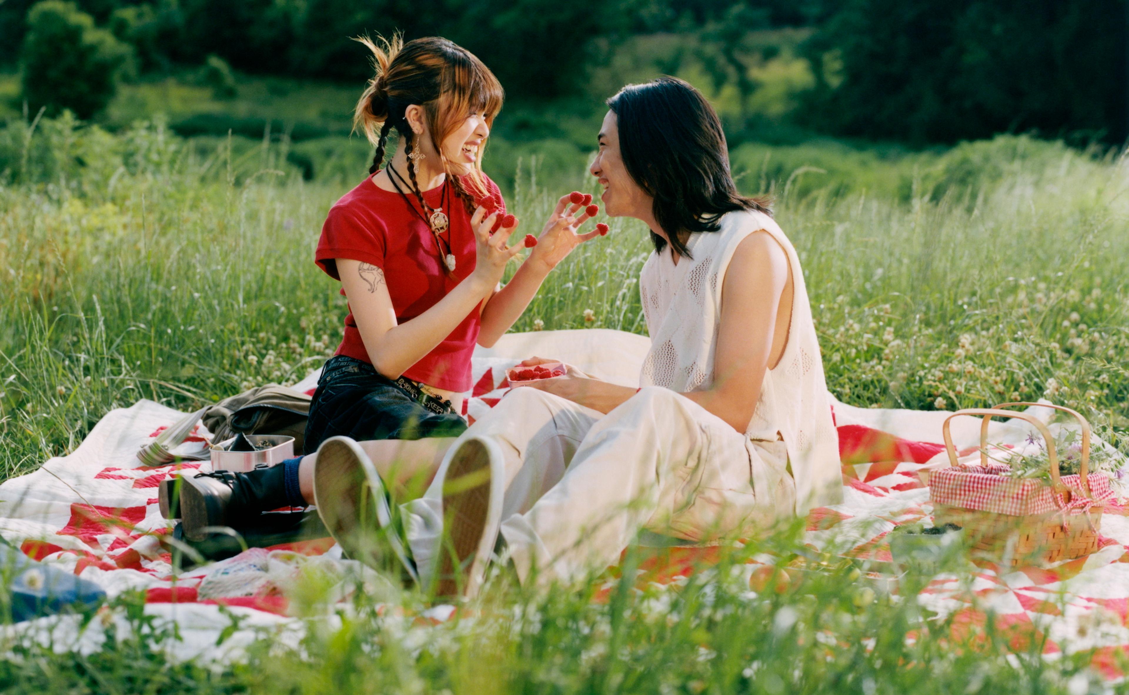 Two people sitting down and laughing together (mobile)